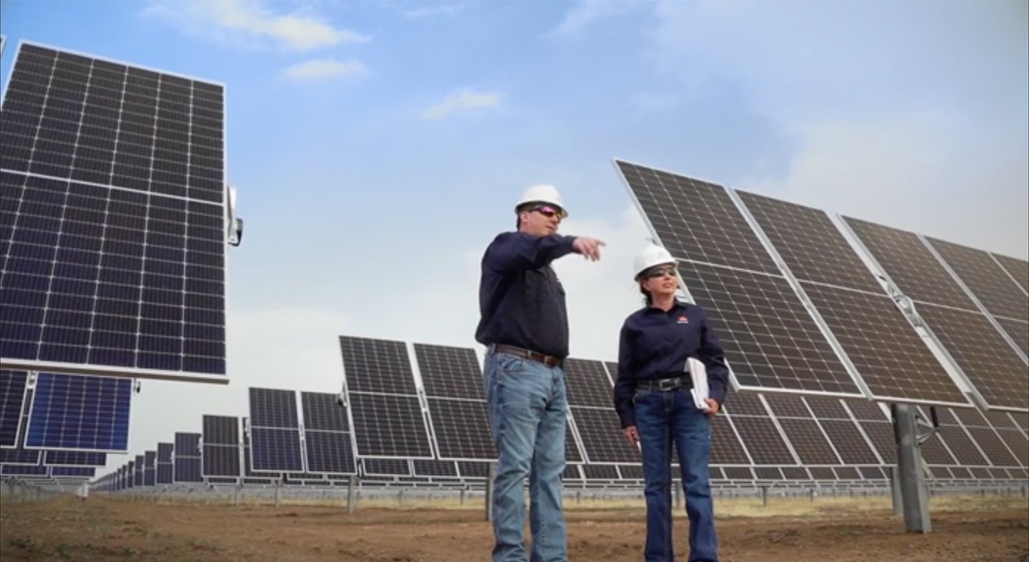 View of Repsol workers next to a solar farm