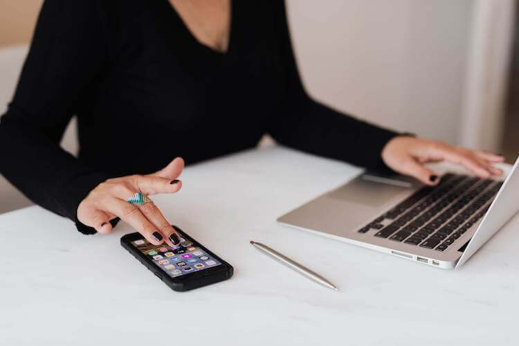 woman with cellphone and computer